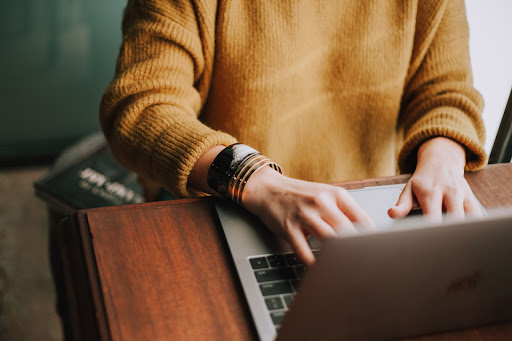 person typing on a laptop