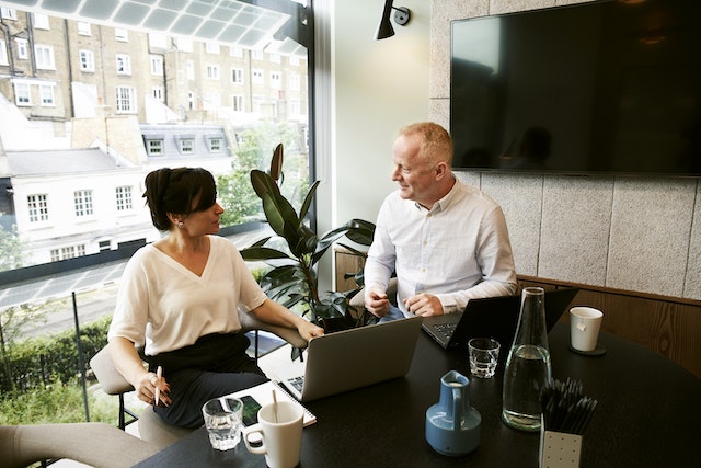 man and woman discussing ideas