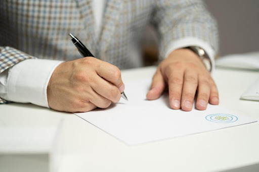 person signing a document