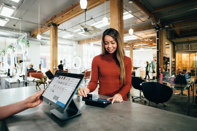 woman paying at the counter